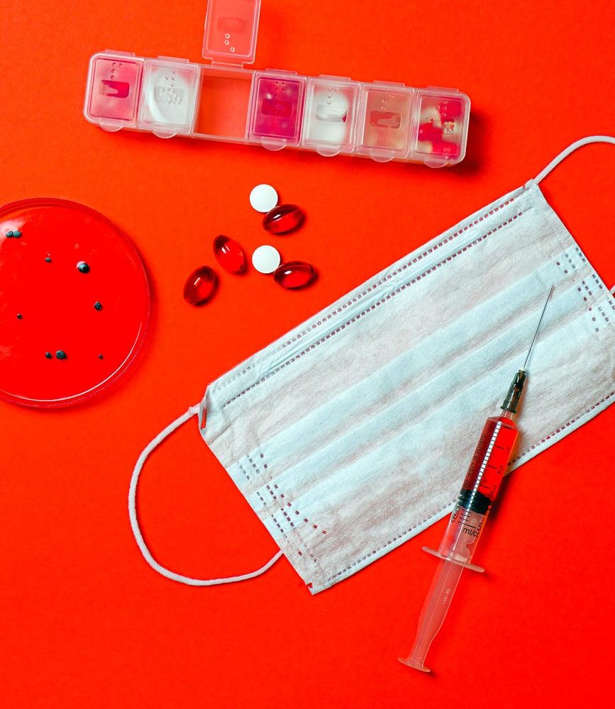 syringe and pills with petri dish